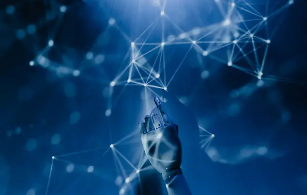 Mano che tocca una rete luminosa di nodi su sfondo blu, simbolo dell'intelligenza artificiale