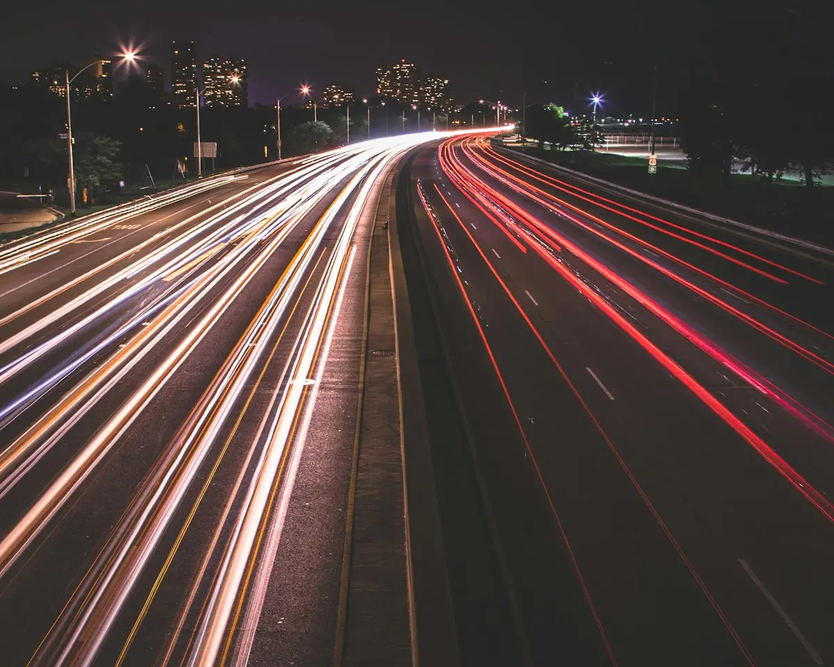 Scie luminose di auto in movimento di notte, immagine che richiama la velocità di inferenza